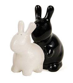 two black and white ceramic rabbits sitting next to each other