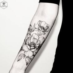 a woman's arm with flowers on it and an instagramr above the arm