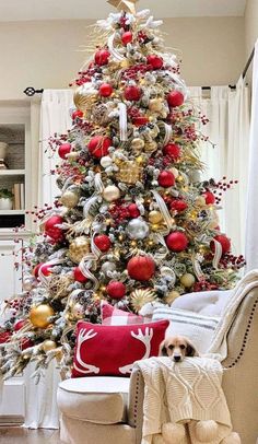 a christmas tree decorated with red, gold and silver ornaments