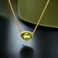 Elegant chic 14k yellow gold oval pendant with one natural pale green peridot weighting 0.50 cts. set in a 14k yellow gold chain. The peridot is known to bring peace, health and rest - by harmonizing the mind and body. It is also thought to boost creativity and improve your mood. Two lengths of the peridot gold necklace: 39.0 - 42.50 cm. / 15.35 - 16.73 inch. Dimensions of the peridot oval-shaped stone: 5.5 * 7.5 mm. / 0.22 * 0.29 inch. MELIGreece's 14k yellow gold green peridot chain necklace, an ideal birthday gift for your wife or simply a spontaneous gift expressing love!  Accompanied by a minimal chic jewelry box and gift packaging. We match it with MELIGreece's heart and diamond cross gold chain necklace https://www.etsy.com/listing/955690747/heart-diamond-cross-18k-yellow-gold?click Formal Yellow Gold Peridot Necklaces, Formal Yellow Gold Peridot Necklace, Gold Peridot Necklace For Formal Occasions, Gold Necklace With Peridot For Formal Occasions, Elegant Peridot Birthstone Necklace, Elegant Lime Green Necklace For Gift, Elegant Lime Green Necklace Gift, Oval Yellow Gold Birthstone Necklace, Yellow Gold Peridot Necklace Gift