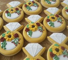 many decorated cookies on a table with flowers and other items in the shape of sunflowers