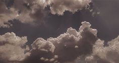 the sky is filled with lots of white clouds in black and white colors, as well as some dark gray ones