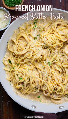 a plate full of pasta with sauce and parsley on the side, next to some breadcrumbs