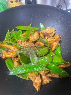 stir fry with chicken and green peppers in a wok