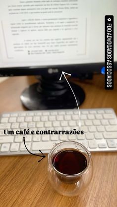 a cup of coffee sitting in front of a computer