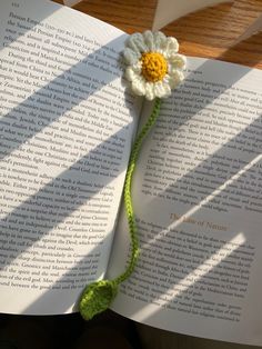 a crocheted flower on top of an open book