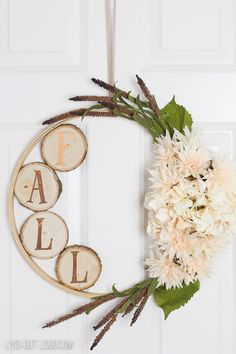 a wreath made out of wood slices and flowers