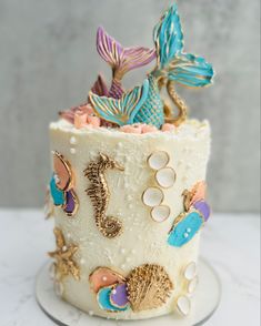 a cake decorated with seahorses, shells and seashells