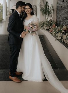 a bride and groom posing for a photo