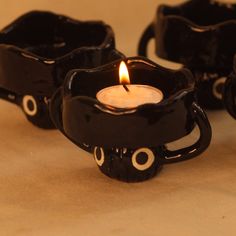 two black candles are sitting on a table