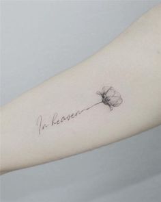 a woman's arm with a small flower on it and the word i'm keven written in cursive ink