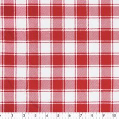 a red and white checkered fabric with a ruler on the bottom right hand side