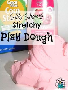 a pink play dough next to a carton of cream