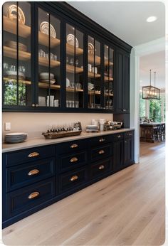 a large kitchen with black cabinets and gold trim on the doors is pictured in this image