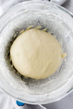 a ball of dough in a glass bowl