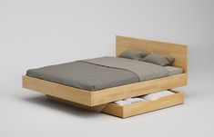 a bed with two drawers underneath it