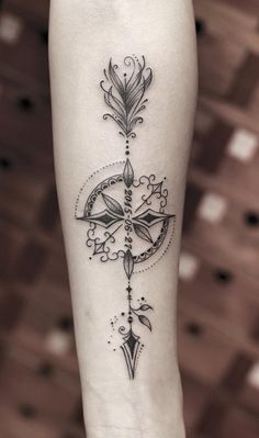 a woman's leg with a cross tattoo on it