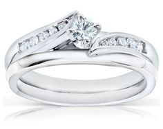 a white gold wedding ring set with two matching bands and a round diamond center stone