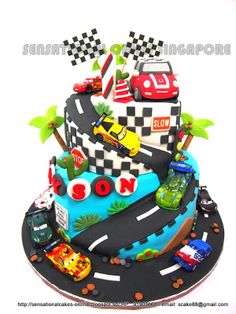 a birthday cake decorated with cars and race flags