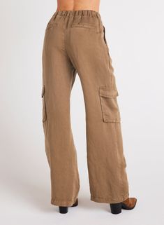 Introducing our latest addition, Jules Pleated Wide Leg. With cargo pockets and pleated detailing. Whether you're going for a casual or a more polished look, this cargo pant is the perfect choice for any occasion. 55% Linen 45% TENCEL™ Lyocell. SIZE WAIST WAIST TO HEM RISE INSEAM XS 26 1/2" 43" 11 7/8" 31 1/2" S 28 1/2" 43 1/2" 12 1/2" 31 1/2" M 30 1/2" 44" 13 1/8" 31 1/2" L 32 1/2" 44 1/2" 13 3/4" 31 1/2" Brown Mid-rise Bottoms With Cargo Pockets, Mid-rise Brown Bottoms With Cargo Pockets, Brown Mid-rise Utility Cargo Pants, Brown Utility Style Mid-rise Cargo Pants, Utility Brown Mid-rise Cargo Pants, Khaki Linen Cargo Pants With Pockets, Khaki Full-length Cargo Jeans With Flap Pockets, Baggy Khaki Cargo Jeans For Workwear, Brown Wide Leg Cargo Jeans With Pockets