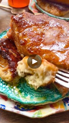 a plate with some food on it and a fork in the foreground that is being used to make pancakes