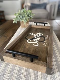 a coffee table with a wooden tray on it