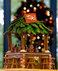 there is a tiki bar on top of the cake, with lights in the background