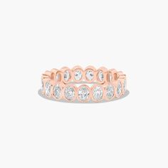 a rose gold ring with white stones