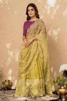 Lime green lehenga with layered hemline and embroidered trim. Comes with embroidered purple blouse and dupatta.
Component: 3
Embroidery
Neckline: Round
Sleeve Length: Half
Fabric: Cotton, Chanderi and Organza
Color: Green,Purple
Dupatta with embroidered and scalloped edge
Closure: Side tie up
Note: Accessory on the waist worn by the model is not for sale
Note: Yellow lehenga set worn by the other model is not for sale - Aza Fashions Designer Green Pre-draped Saree With Chikankari Embroidery, Designer Green Chikankari Embroidery Pre-draped Saree, Pista Green Chikankari Embroidery Floor-length Lehenga, Purple Chanderi Choli With Sheer Dupatta, Purple Sharara With Chikankari Embroidery For Navratri, Purple Chikankari Embroidered Sharara For Navratri, Pista Green Chikankari Embroidery Lehenga, Purple Lehenga With Chikankari Embroidery For Wedding, Purple Chikankari Embroidery Sharara For Navratri