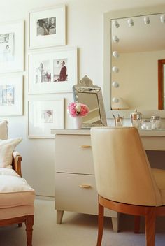 a bedroom with pictures on the wall and a vanity