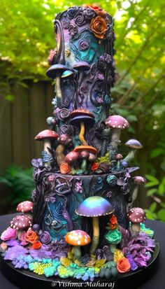 the cake is decorated with many different types of mushrooms and flowers on top of it