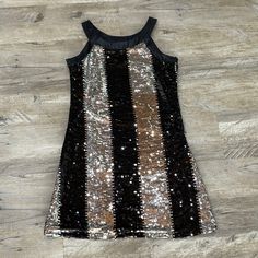 Woman’s Black And Silver Sequin Dress. Rhapsody Brand. Never Worn, New Without Tags. Has Zippered Side. Smoke Free/Pet Free Home. Metallic Sleeveless Dress For Costume Party, Black Mini Dress With Contrast Sequin For Holiday Party, Black Contrast Sequin Mini Dress For Holiday Party, Fitted Dress With Contrast Sequin For Dress-up, Sleeveless Sequin Dress For Party Season Dress-up, Sleeveless Sequin Dress For Dress-up And Party Season, Black Contrast Sequin Dress For Costume Party, Black Shimmer Dress For Night Out, Black Shimmer Dresses For Night Out