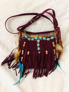 Dreamy bohemian feathers, charms and beads bag 💕 Deep burgundy with pendant turquoise colored metallic charm attached with vintage 1980s sari ribbon in front of bag. Vintage Sari strips are affixed to the sides of this cute purse and next to it are handmade feather charms in lovely beige and deep aqua blue feathers dangle from the sides. They match the pendant turquoise charm on the front.  cute one of a kind, fringe crossbody bag, beautiful deep burgundy color perfect for autumn outings, origi Bohemian Bags With Beaded Fringe For Everyday Use, Bohemian Festival Bags With Beaded Fringe, Bohemian Brown Bag With Beaded Fringe, Red Bohemian Shoulder Bag With Tassels, Bohemian Purple Shoulder Bag With Adjustable Strap, Bohemian Shoulder Bag With Tassels, Red Bags With Tassels For Festival, Bohemian Bags As Festival Gift, Bohemian Bags For Festival Gift