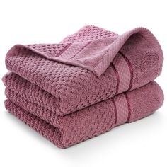 three pink towels stacked on top of each other