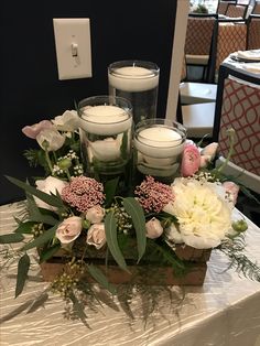 flowers and candles are arranged on a table