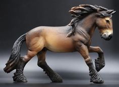 a toy horse that is standing on its hind legs and it's mane blowing in the wind