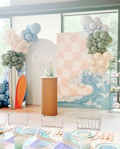 a table set up with plates and place settings for an ocean themed birthday party at home