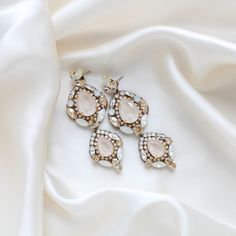 Feel like a modern-day royalty with our luxurious GIANNA statement bridal earrings. Handcrafted with dazzling Austrian crystals, the earrings make a bold and sophisticated statement. Perfect for all special occasions! PLEASE ALLOW APPROX 10 BUSINESS DAYS FOR COMPLETION BEFORE SHIPPING- Handcrafted with Austrian crystals - Each stone is set by hand in my studio- Golden shadow, ivory cream, white opal and clear stones- Antique gold finish- Earrings measure 3.25 inches x 1.125 inch- Handcrafted in the US.- Nickel free and hypoallergenicThis is an original design by © Treasures by Agnes FOR MATCHING PIECES SIMPLY TYPE "GIANNA" IN THE SEARCH BAR Luxury Rhinestone Wedding Earrings, Luxury Rhinestone Earrings For Wedding, Glamorous Bridal Earrings With Diamond Accents And Crystal, Elegant Jeweled Crystal Earrings For Wedding, Crystal Embellished Drop Bridal Earrings, Opulent Silver Earrings For Wedding, Evening Jeweled Crystal Bridal Earrings, Silver Glamorous Crystal Earrings For Events, Evening Bridal Jeweled Crystal Earrings