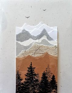 a piece of paper with trees and mountains on it