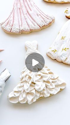 some cookies are decorated with icing and other things to make them look like dresses