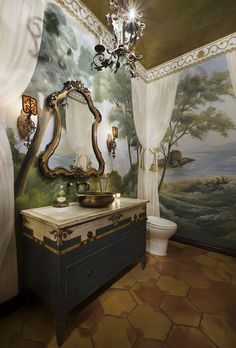 a bathroom with a painting on the wall and a chandelier hanging from the ceiling