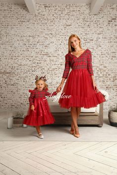 the mother and daughter are dressed in red dresses