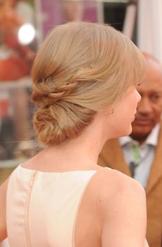 the back of a woman's head with her hair in a low bun