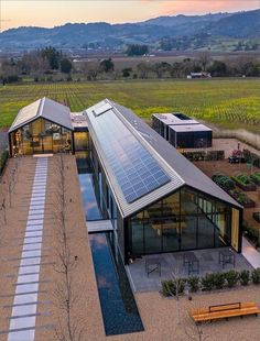 an aerial view of a house with solar panels on the roof