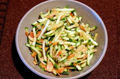 a bowl filled with vegetables sitting on top of a table