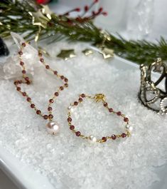 Buy individually or as a set & save!Choose from beautifully faceted Garnet rosary style chain, accented with lustrous Freshwater Pearls. Gorgeous classics with a bit of flair & color!Necklace: Rosary style faceted Garnets are accented with a lustrous 9 X 10mm Freshwater Pearl, which is hand wired to the center of the necklace. The Pearl pendant can be removed if you choose to wear them separately or the pendant on a different chain.Length: 16" with 2" extenderBracelet: Faceted Garnets are wire w Elegant Briolette Jewelry With Faceted Beads, Elegant Adjustable Christmas Necklaces, Briolette Polished Beads Jewelry Gift, Elegant Christmas Adjustable Necklace, Elegant Jewelry With Faceted Rondelle Beads, Elegant Rondelle Jewelry With Faceted Beads, Elegant Christmas Jewelry With Faceted Beads, Christmas Gift Jewelry With Faceted Beads, Elegant Necklaces With Faceted Beads For Festive Occasions