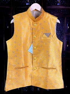 Premium quality Silk Men's Waist Coat in Yellow Color gorgeous Zari Weaving Floral designs. Can be paired with a Kurta Pajama Set. Item : Men's Jacket Ready to Wear : Yes Jacket Color : Mango Yellow Fabric : Raw Silk Work : Fancy buttons, Self Deign Pattern Material Pattern : Designer Lining : Yes Measurements of the Jacket Size - 38 Chest : 40 inches Length : 27 inches Size - 40 Chest : 42 inches Length : 27 inches Size - 42 Chest : 43 inches Length : 27 1/2 inches Size - 44 Chest : 44 inches L Fitted Nehru Jacket For Groom In Transitional Season, Traditional Gold Nehru Jacket For Groom, Festive Nehru Jacket With Stand Collar For Wedding, Yellow Bandhgala For Wedding, Yellow Bandhgala For Wedding And Transitional Season, Yellow Fitted Bandhgala For Wedding, Yellow Nehru Jacket With Zari Work For Wedding, Gold Nehru Jacket For Groom, Festive Occasion, Traditional Fitted Nehru Jacket For Celebration