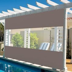 a swimming pool with a pergolated cover over it and some chairs near by