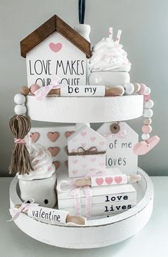 a three tiered cake stand with cupcakes and other items on it,