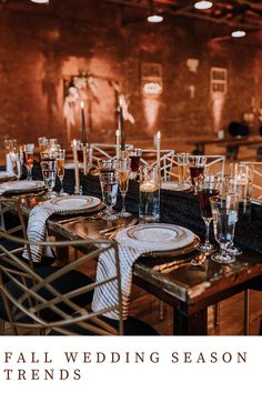 a table set up for a formal wedding with wine glasses and place settings on it